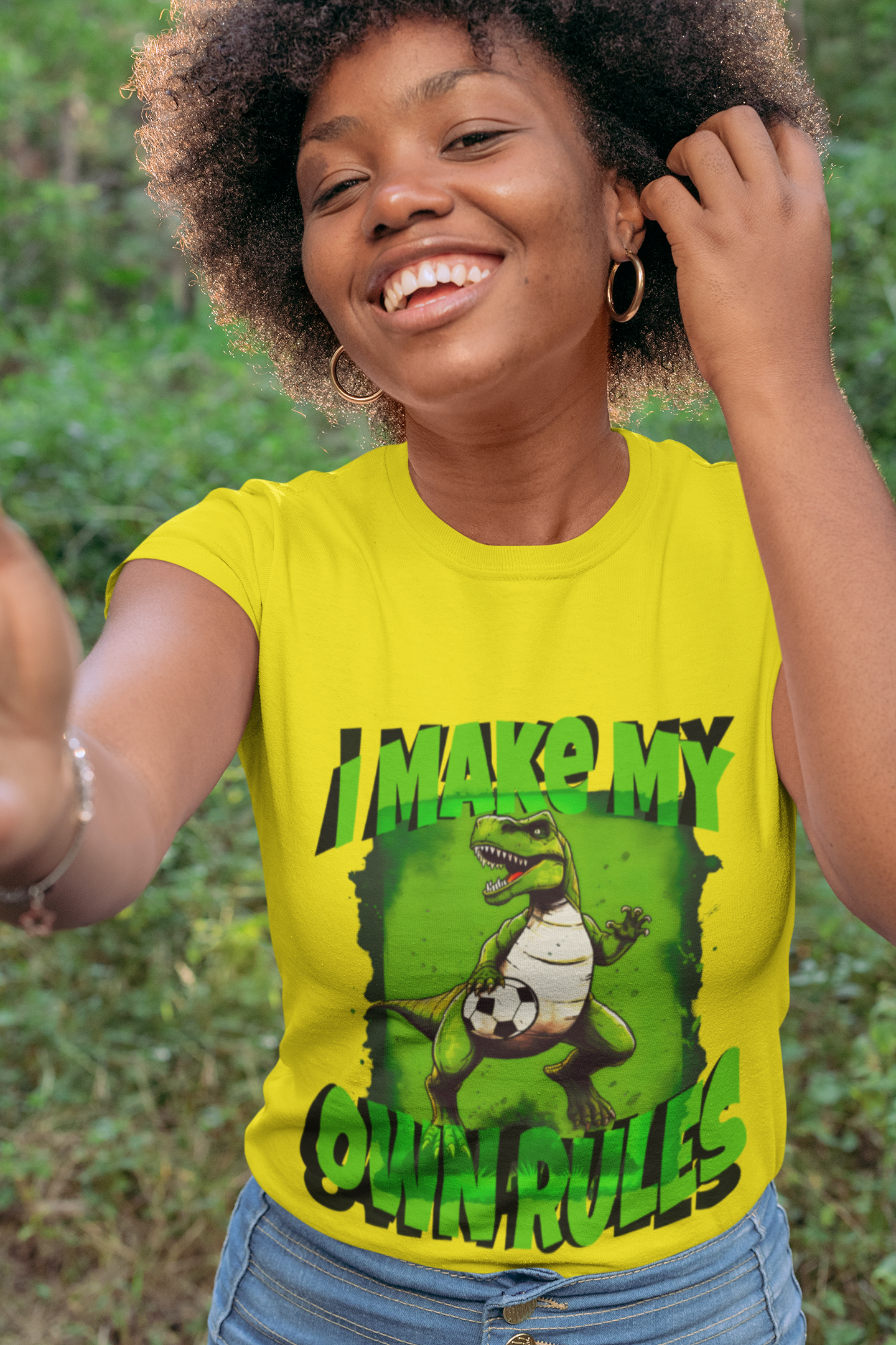 Yellow T-shirt Model image: Looking to show off your inner rebel on and off the soccer field? Look no further than this T-Rex soccer design tee! The realistic T-Rex design and bold lettering proclaiming "I make my own rules" is the perfect way to showcase your individuality and independence